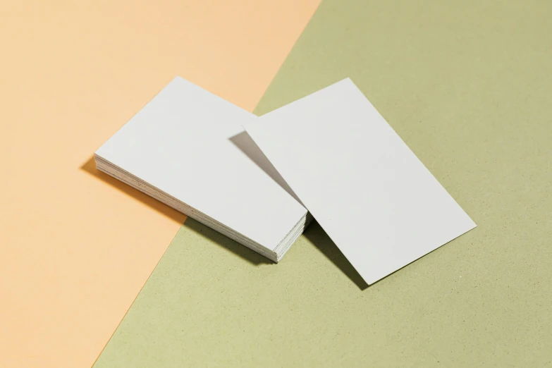 two white business cards laying on one another