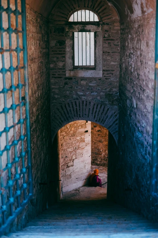 a prison cell with bars and the door is open