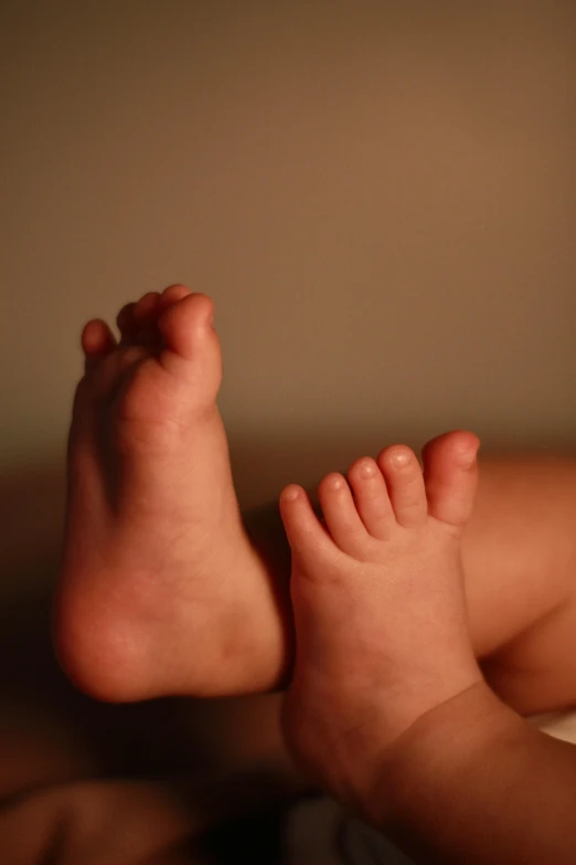 a bare child is laying down on a bed