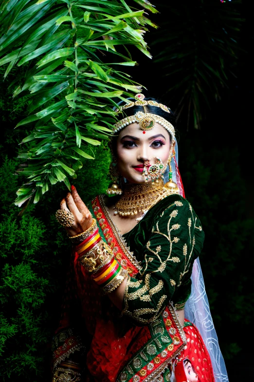 a woman in traditional indian dress is holding soing up