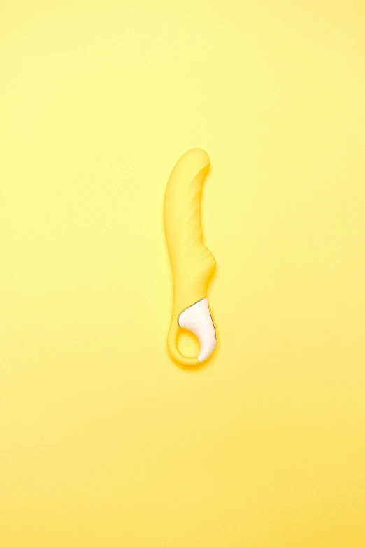 a computer mouse and a banana peel on a yellow background