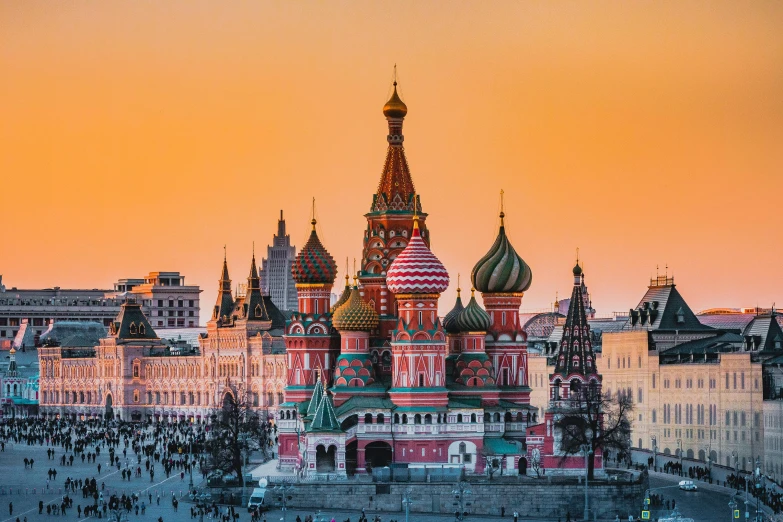 a red and white cathedral with a city in the background