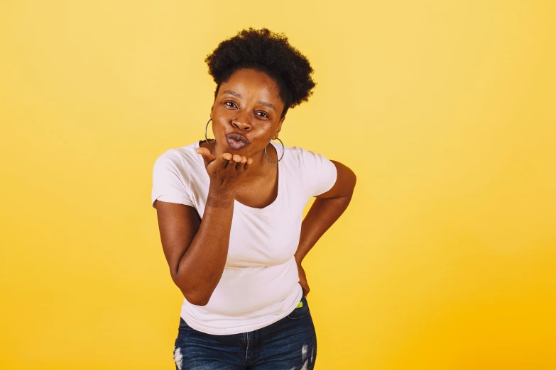 a beautiful young woman holding her mouth up