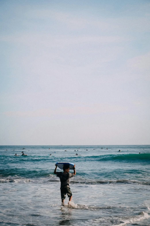 a man holding an umbrella while walking in the water