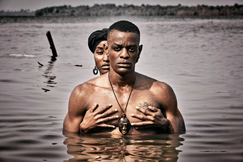 a man and a woman are in the water with one wearing a headband