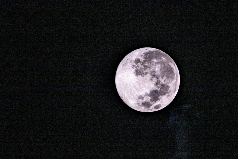 the moon is seen against a dark sky