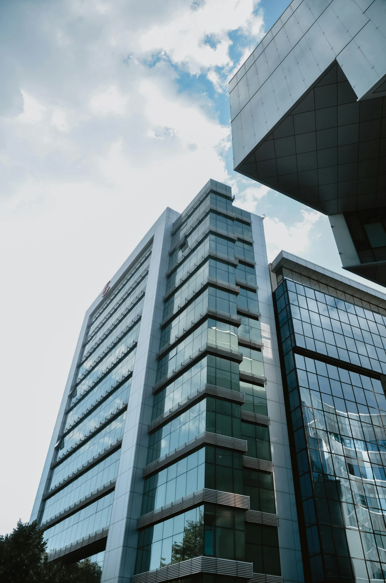 a tall building in front of a cloudy sky