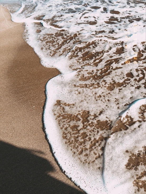 ocean waves crashing onto a sandy beach