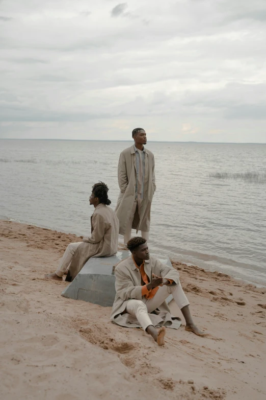 several people that are sitting on a beach