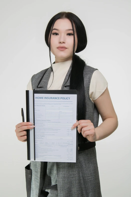 a young lady holding up an official document