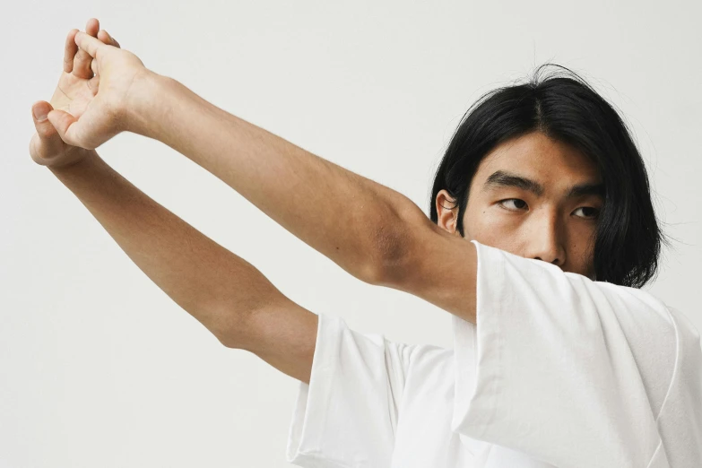 man in white shirt with arm outstretched up