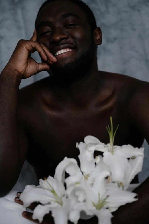 a man holding a bouquet of flowers in his hand