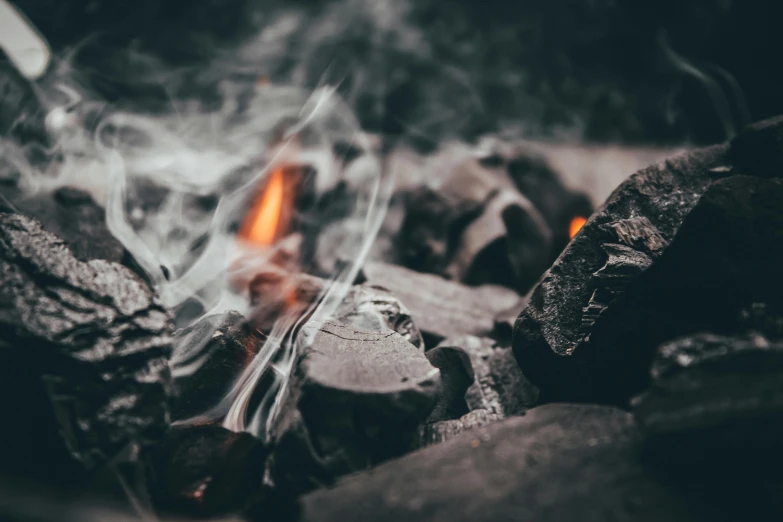 closeup po of flames and rocks with water and smoke