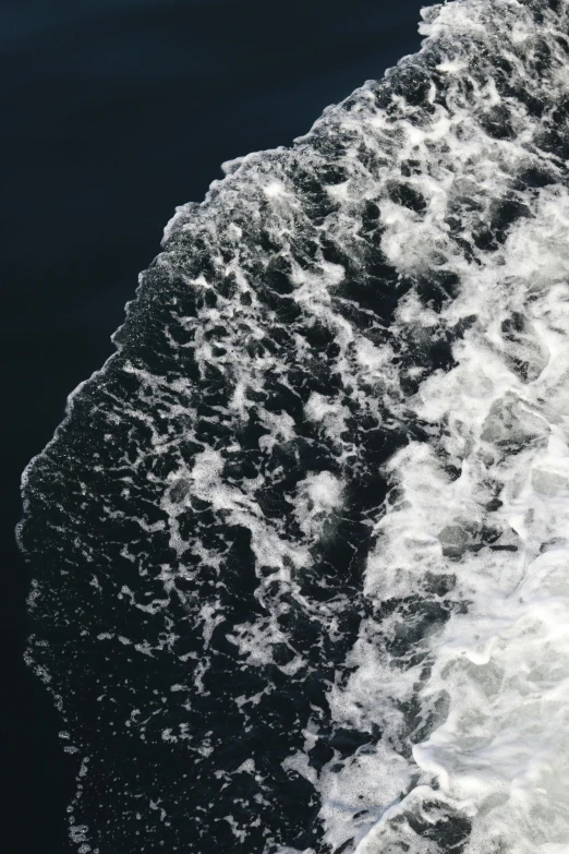 the small surfboard is being held close to the shore