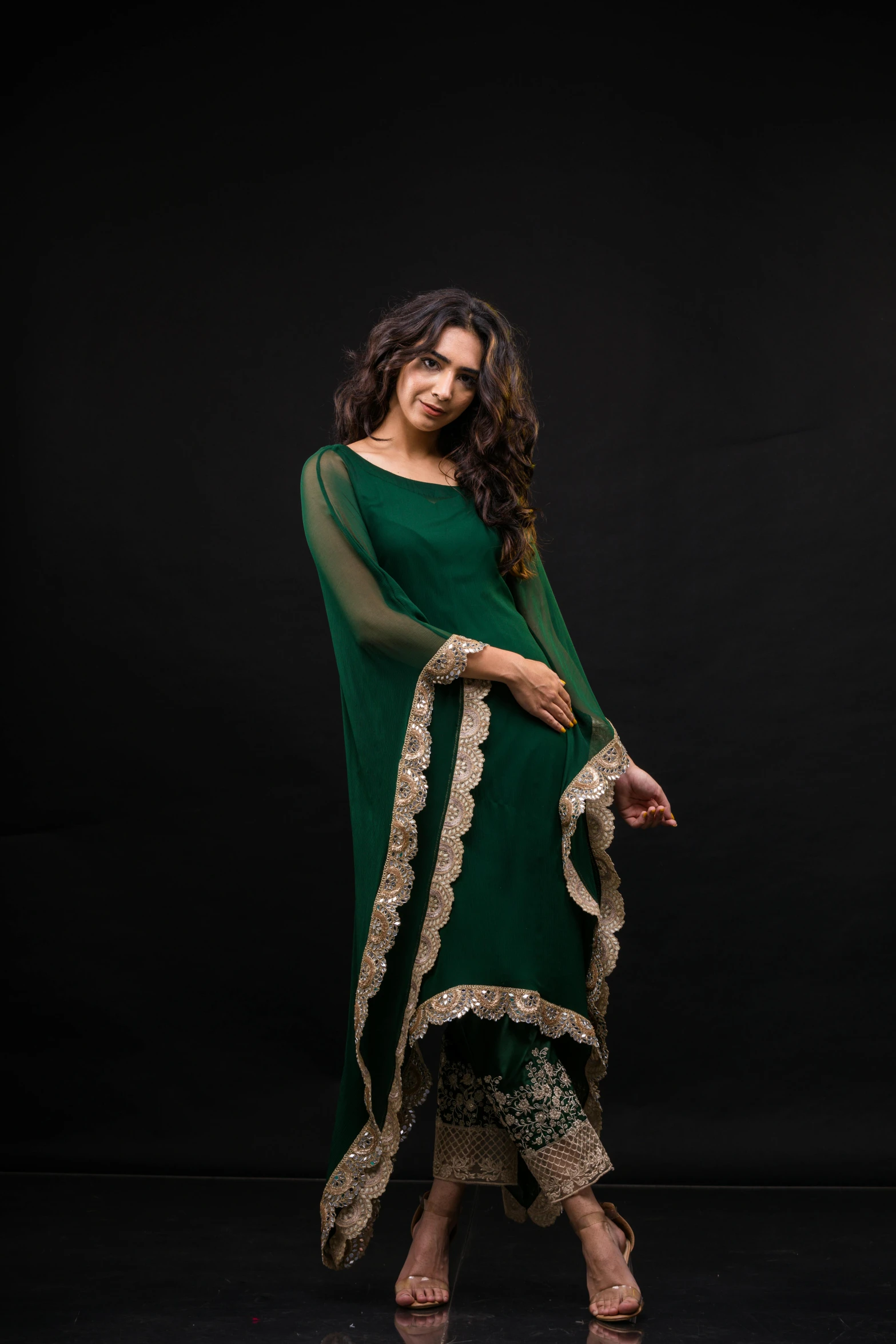 an indian woman dressed in green posing for a po