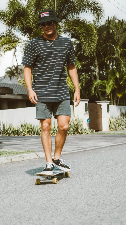 man riding on a skate board while wearing a hat