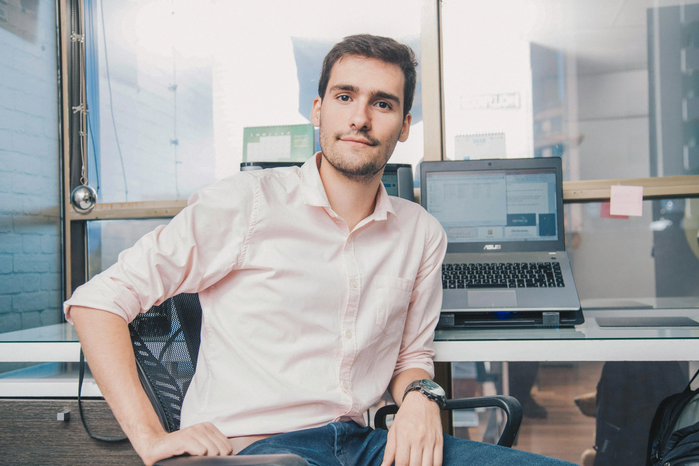 a man that is sitting down by a desk