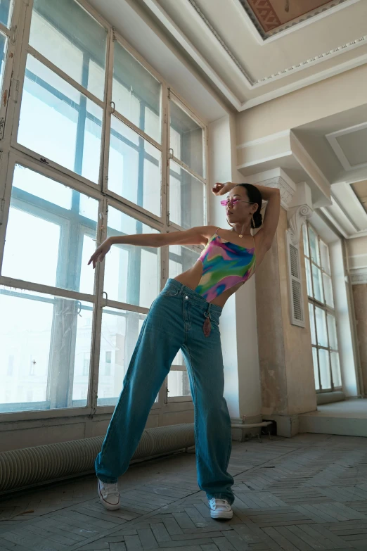 a woman standing with her arms spread in an empty building