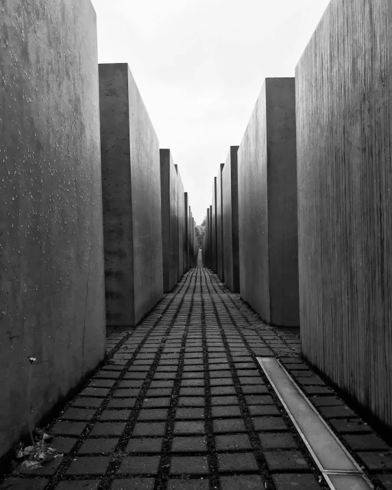 a black and white po of a street lined with cement blocks
