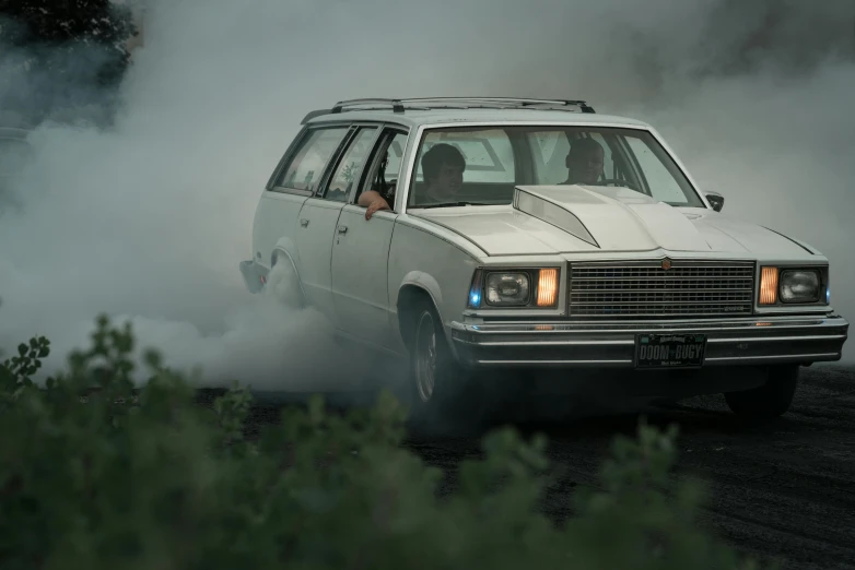 the back of a wagon in front of a building surrounded by fog