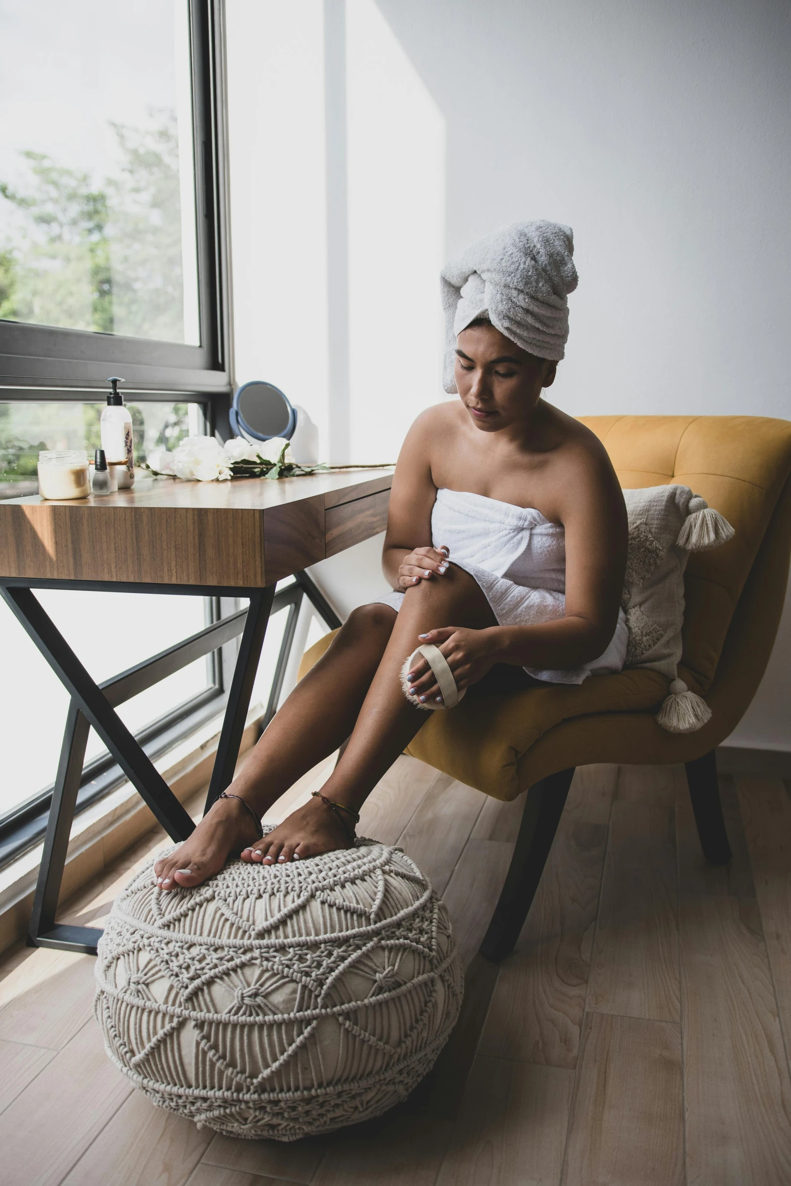 a woman is sitting in an indoor chair with a big ball on it's back