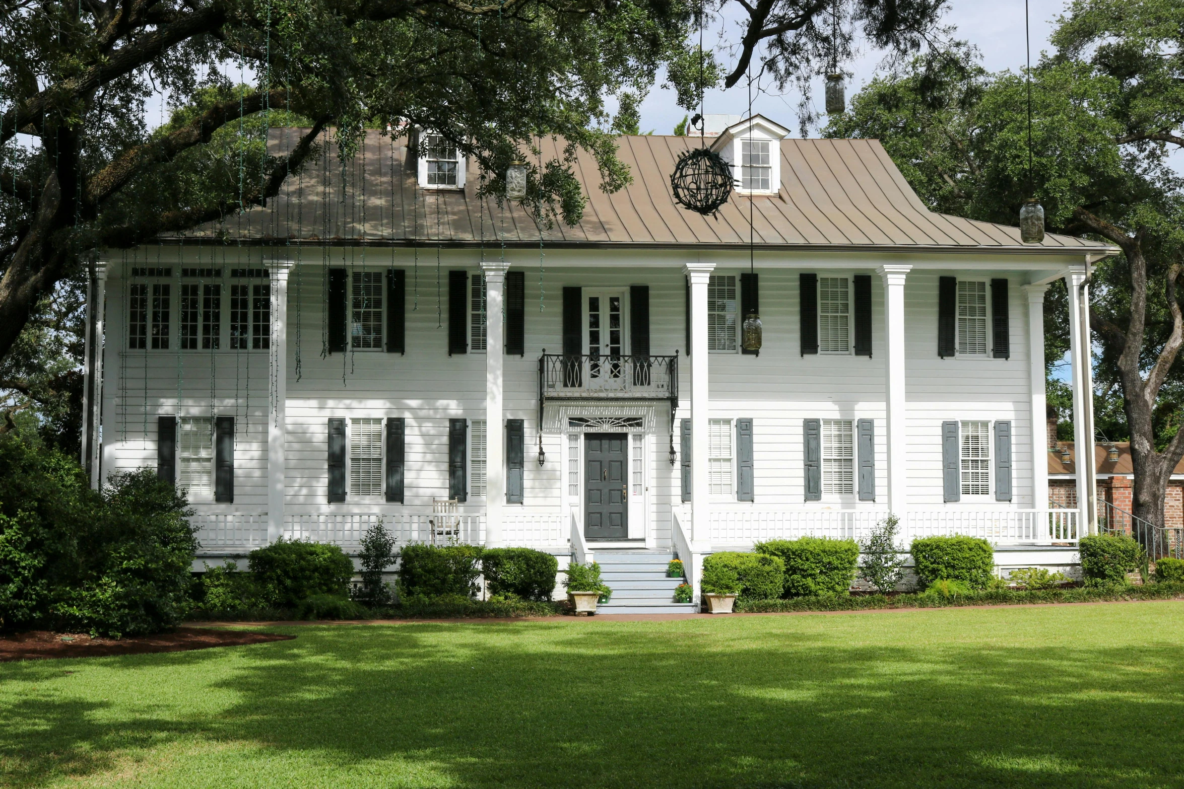 a house with white trim and green grass