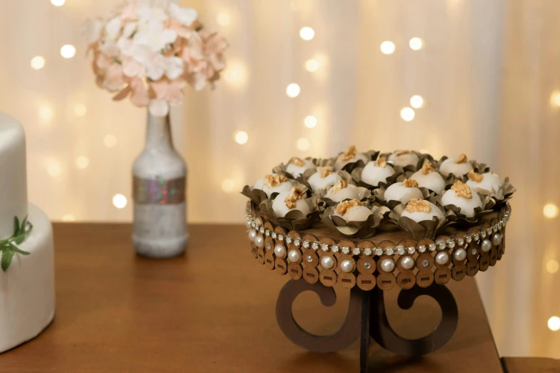 there is a small cake and a bouquet of flowers on the table