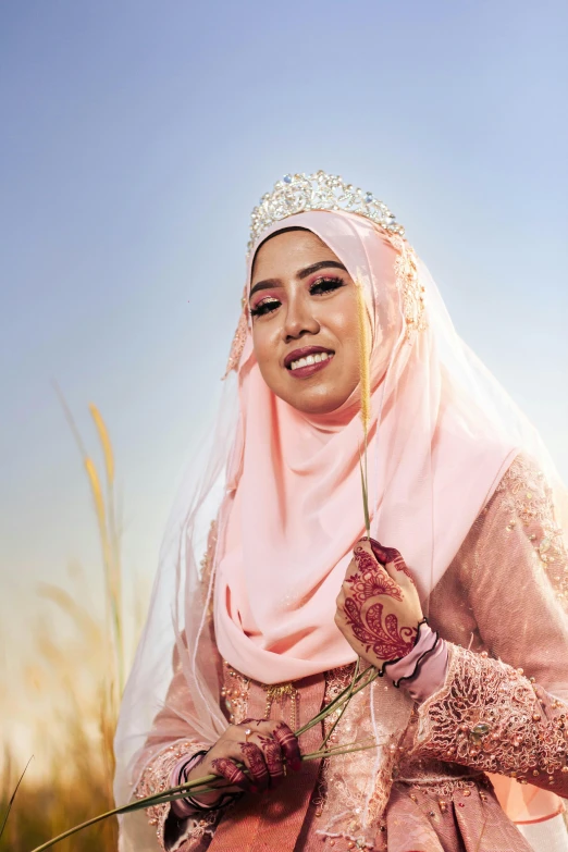 a woman in a veil and dress is holding flowers