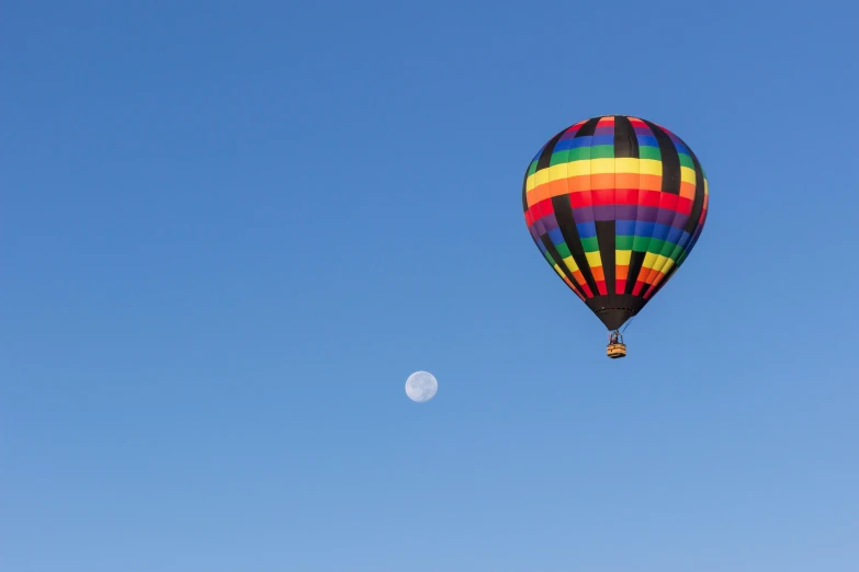 the balloon is up in the sky and has half moon