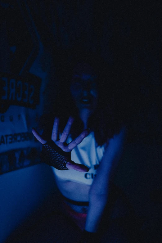 the woman is using her cell phone in the dark