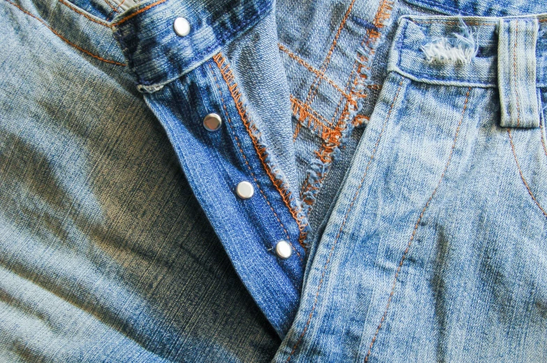 a pair of jean pants is folded to show ons