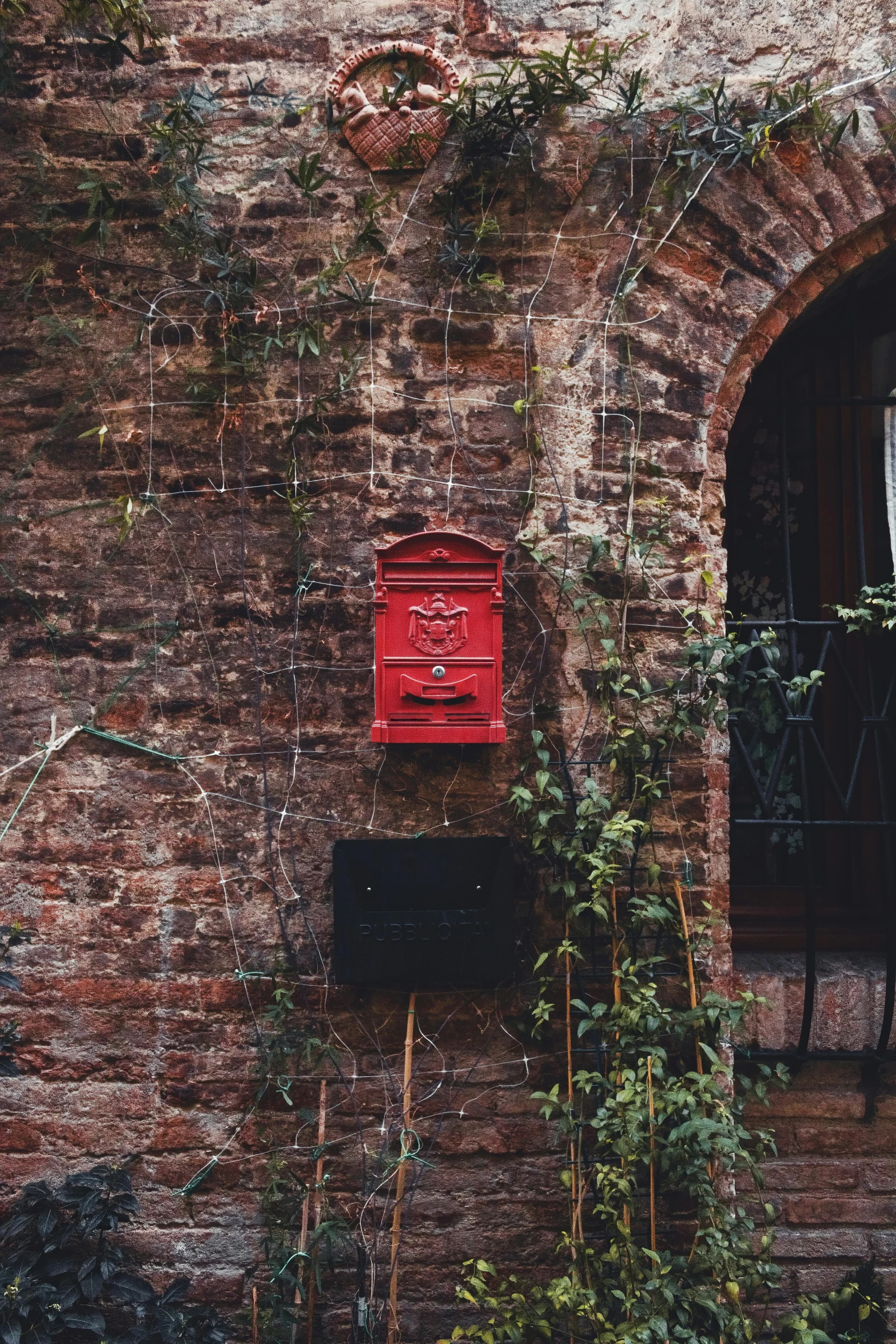 a red light box on the side of a brick building