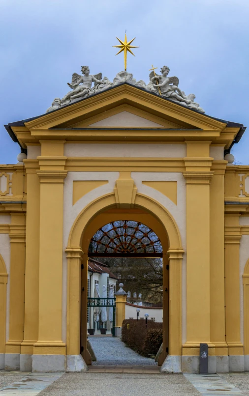 an open church doorway that has a cross on top of it