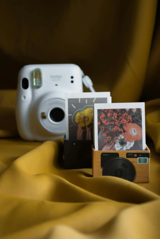 a camera and some pictures on a table