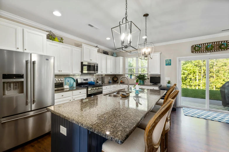 a kitchen that has a light hanging over the refrigerator