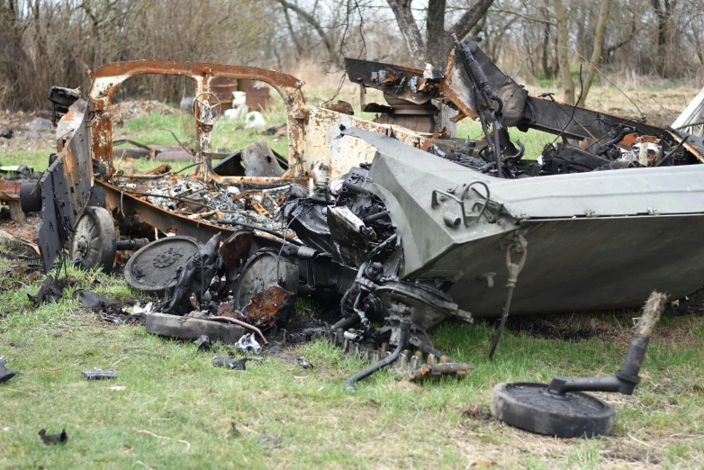 old cars that have been wrecked in an open area