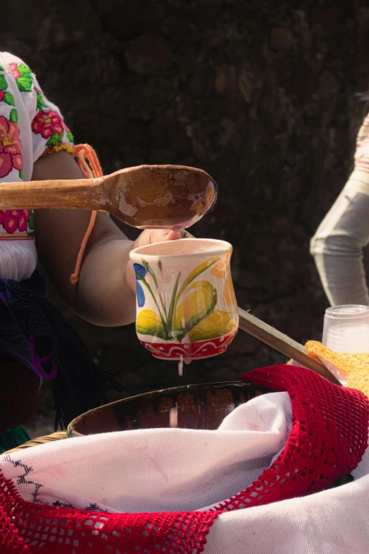 a woman cooking food on a tray that is being served