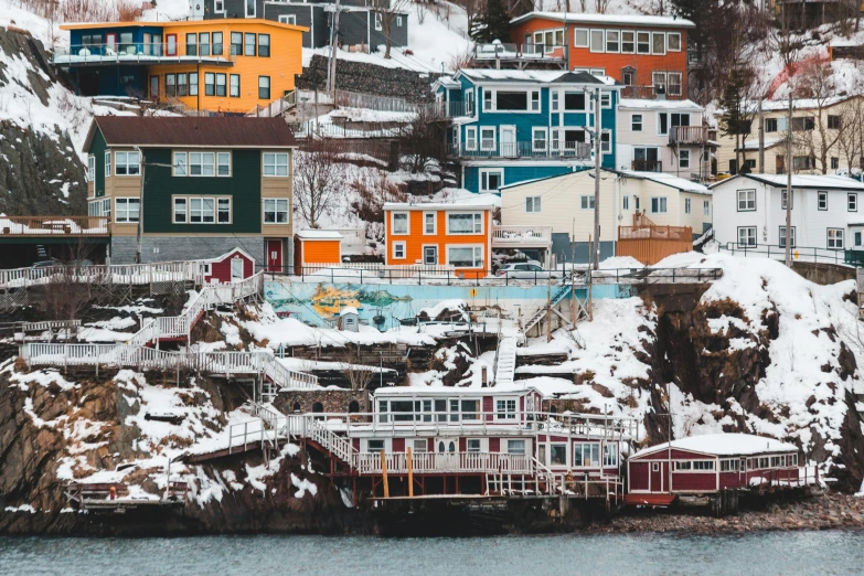 a view of snow covered houses along the shore