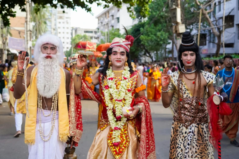 four people with white hair and costumes stand side by side