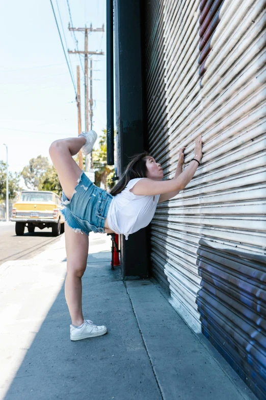 there is a woman that is leaning against a wall