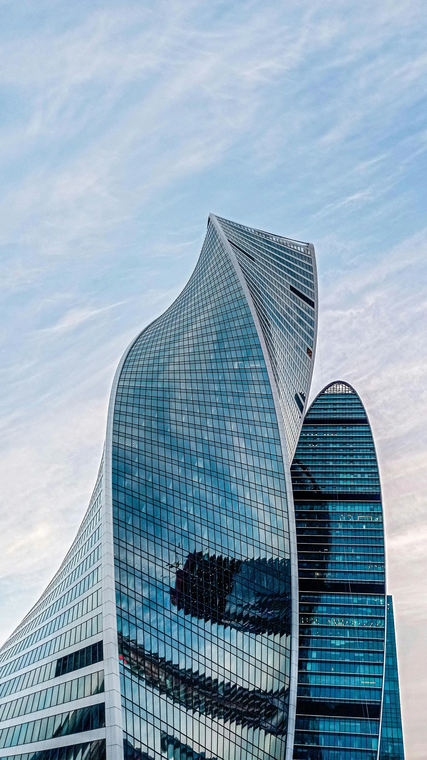 a skyscr building with two circular shaped glass windows