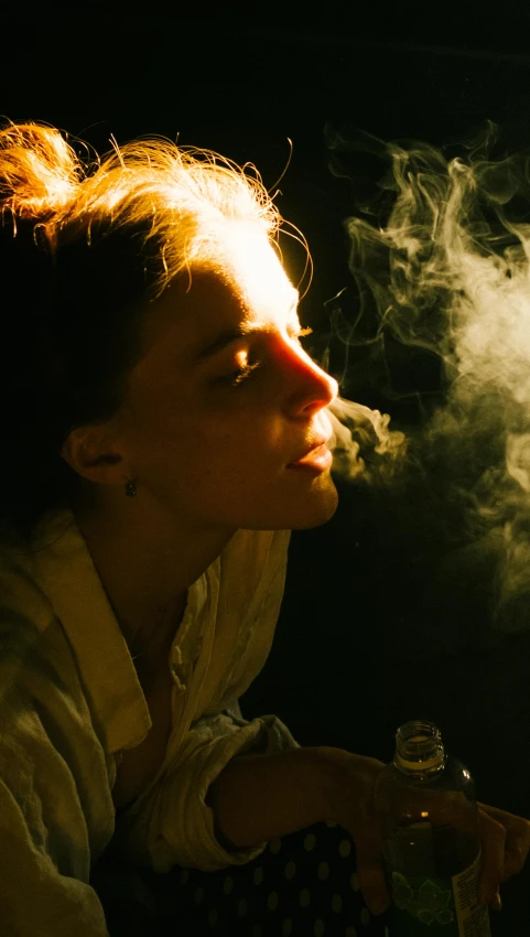 a woman smoking with a glass and lighter