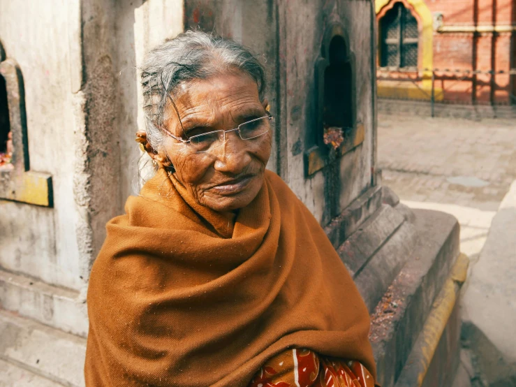 an old woman with grey hair wearing a sari