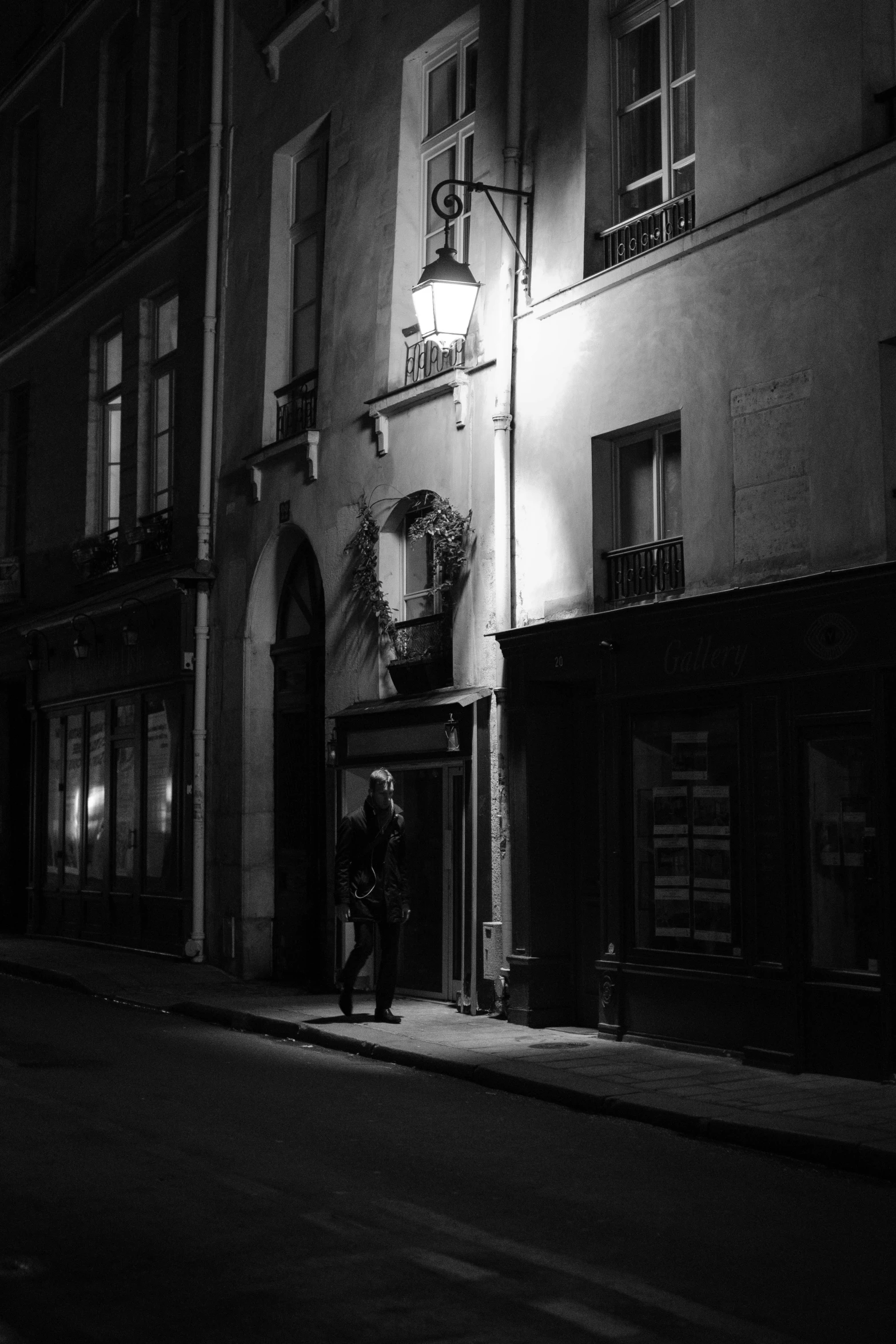 two people walk down an alley in the dark