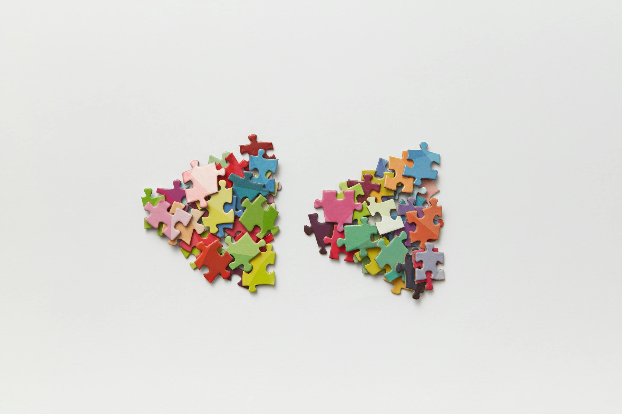 a large pile of different colored pieces of jigsaw