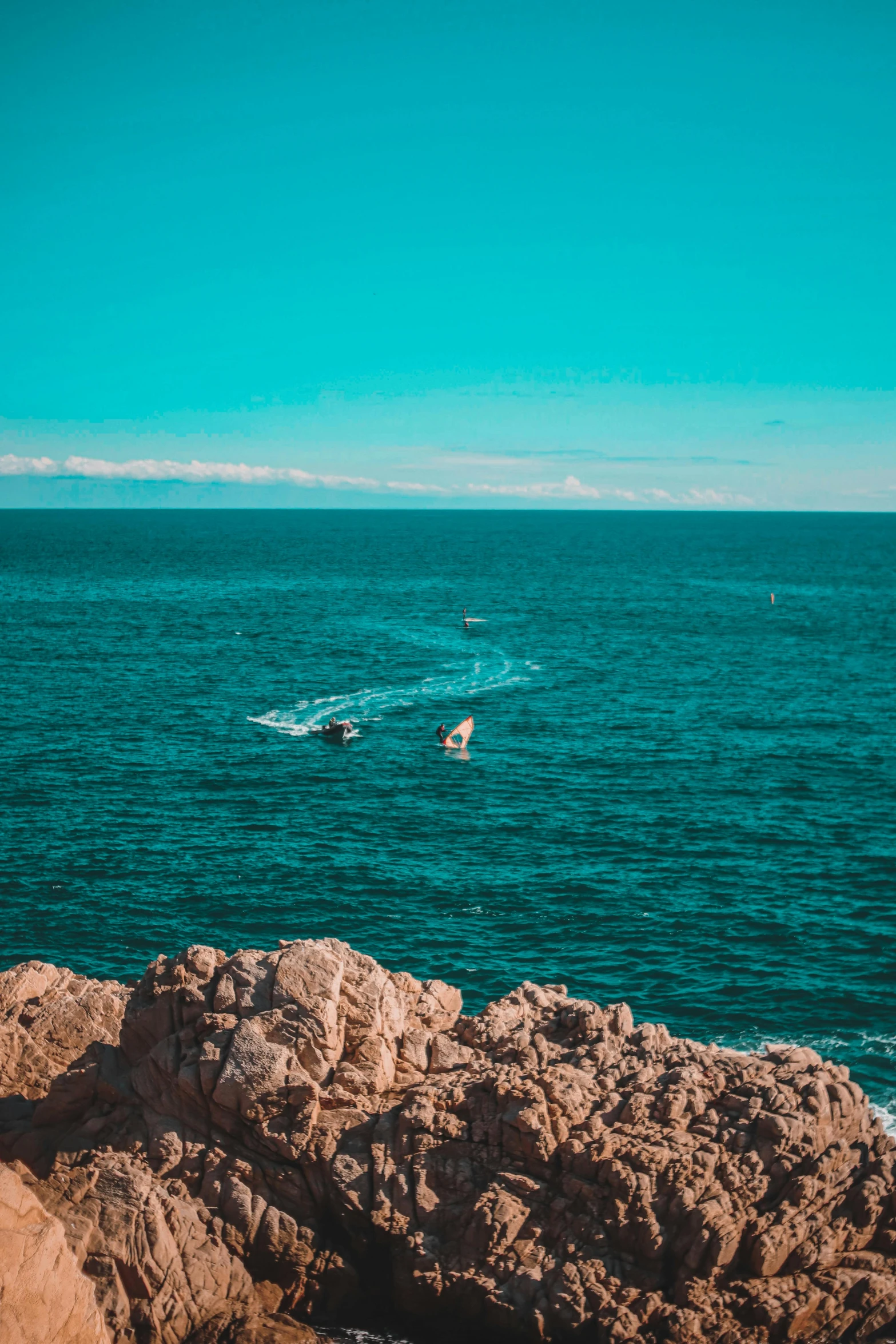 there is a boat floating in the blue water