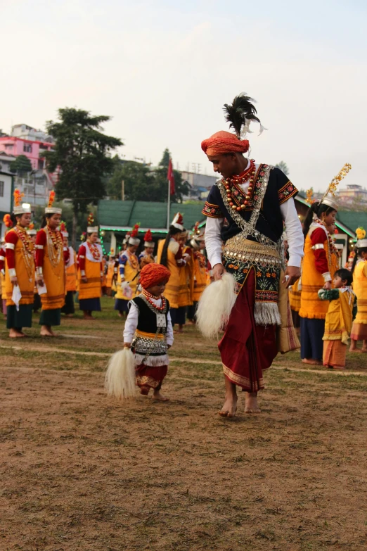 a person dressed in a native costume and other people