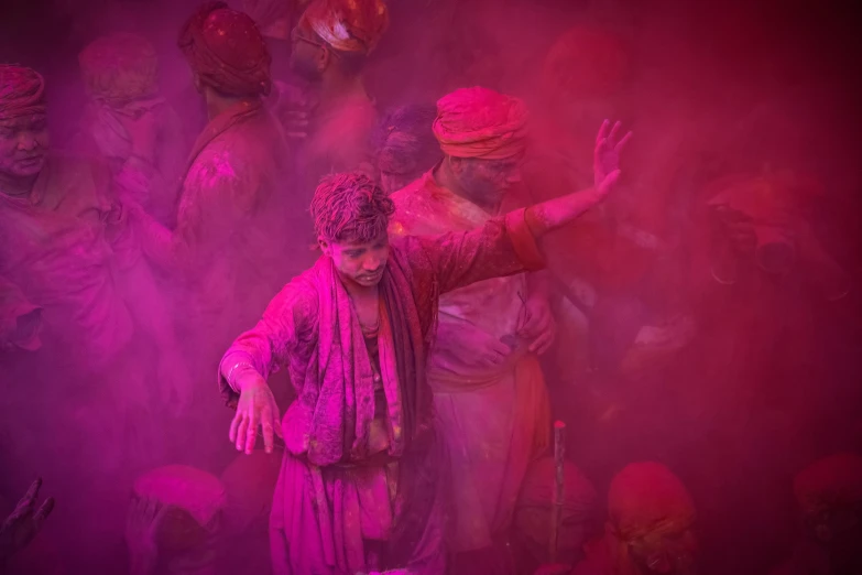 many people are colored and covered in purple paint