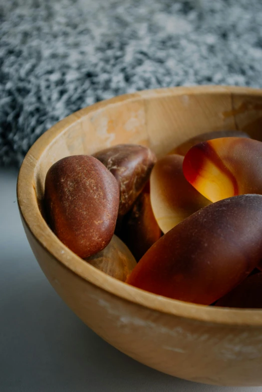 a bowl filled with fresh fruit sitting on top of a table