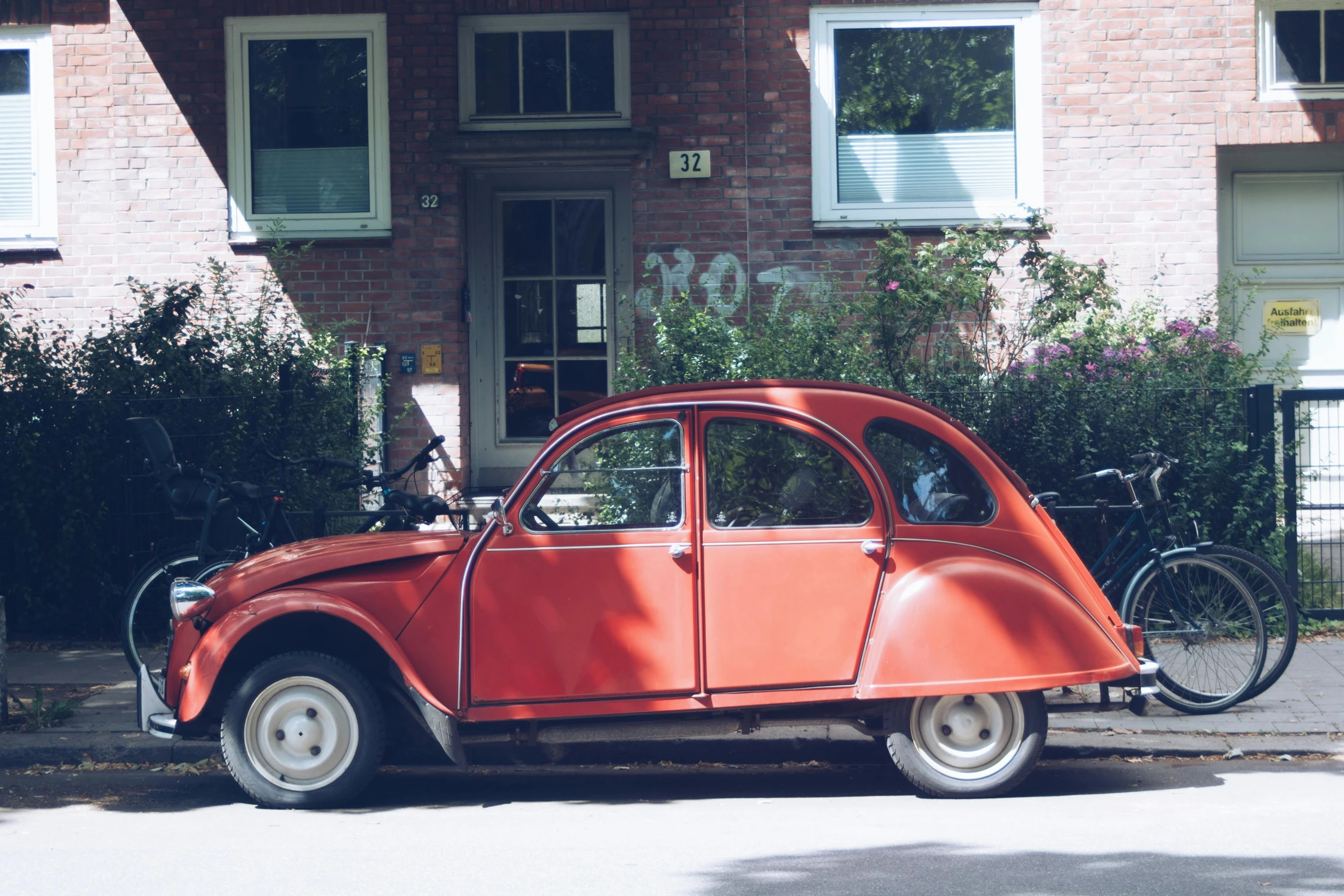 an old style car parked in front of a house